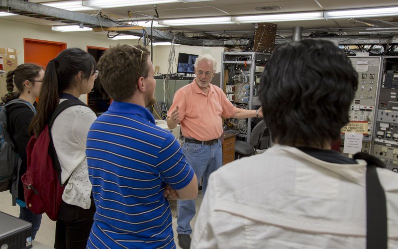 students listen to a presentation by Prof. William Lanford inside the Ion Beam Lab at UAlbany