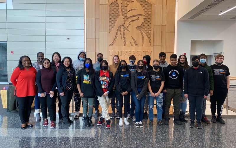 DeeDee Bennett Gayle stands with students and staff in the Rise High Program inside the ETEC atrium.