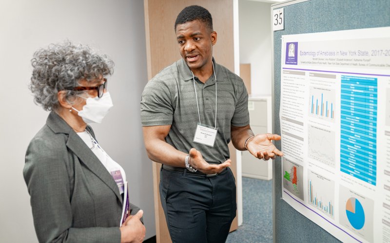 Health Commissioner Dr. Mary Bassett looks at a student poster at the UAlbany School of Public Health poster day.
