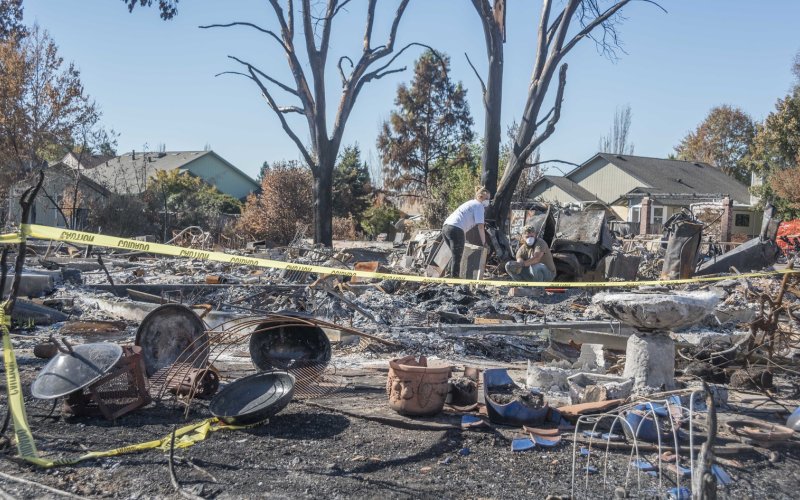 A couple sifts through the ashes of a fire-destroyed home in Santa Rosa, California.