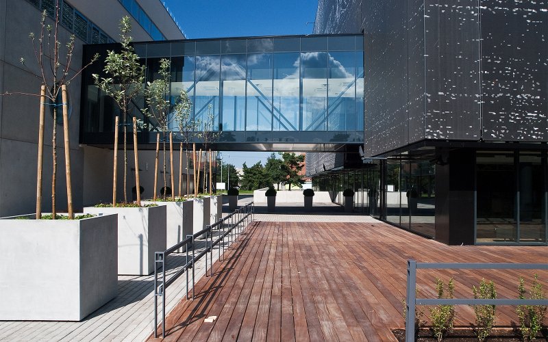 An elevated glass walkway between buildings at Tallinn University of Technology in Estonia.