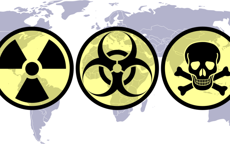 World map with WMD hazard symbols superimposed on it.
