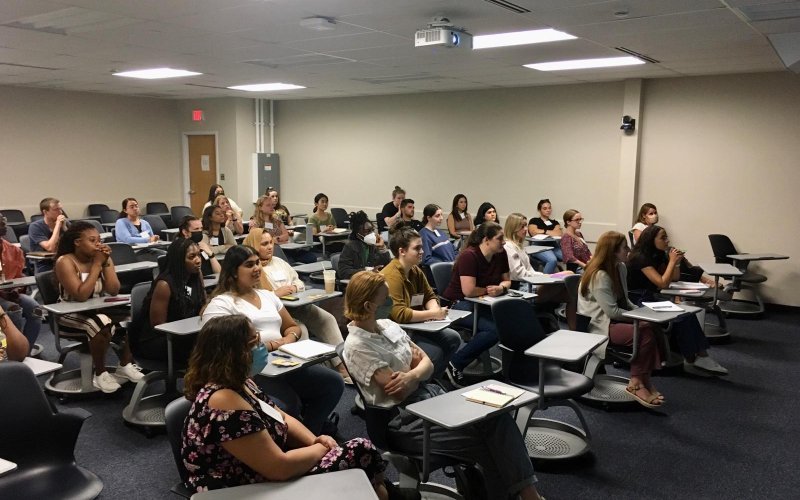 Students gather in a classroom to participate in the Global Health Seminar Series