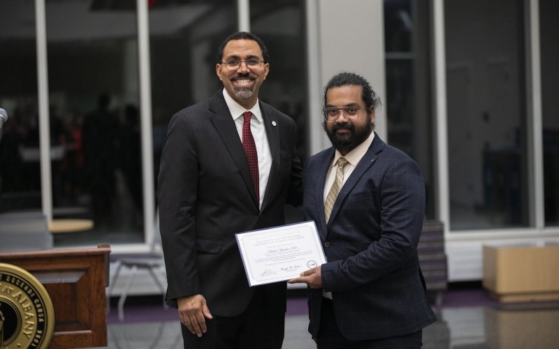 SUNY Chancellor John B. King Jr. presents Arshad Arjunan Nair with the Graduate Dissertation Award at ETEC.