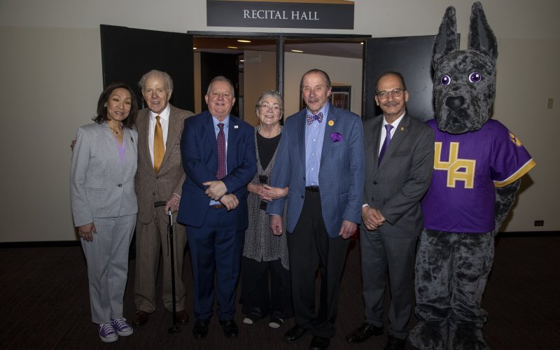 Representatives from UAlbany and the New York State Writers Institute stand in front of the Recital Hall ahead of the NYSWI's 40th Anniversary Celebration.