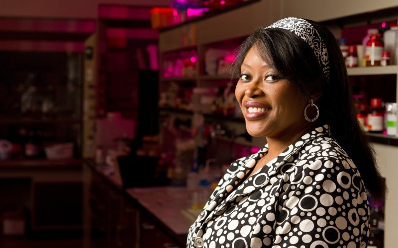 Rabi Musah smiles inside her lab space on campus.