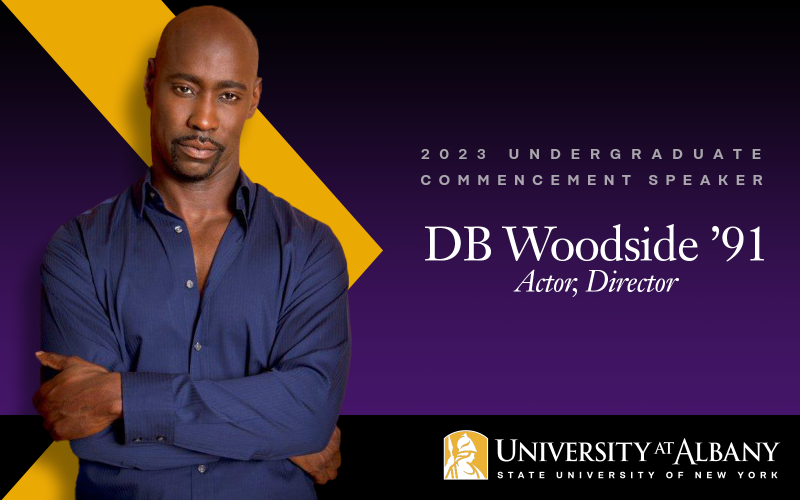 DB Woodside in a blue button-down shirt with the words 2023 undergraduate commencement speaker, University at Albany
