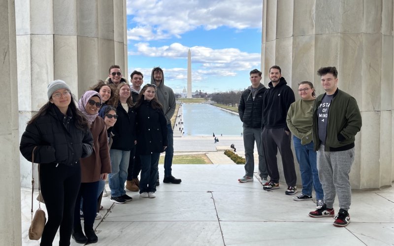 UAlbany's Semester in Washington cohort stand in front of the Washington Monument.