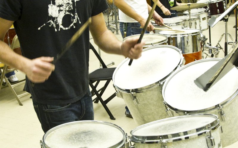 musicians at drum sets with mallets