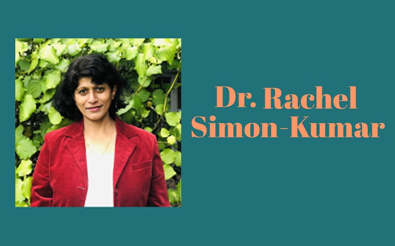 Teal graphic featuring a photo of Dr. Rachel Simon-Kumar, with short dark hair and a red blazer standing in front of greenery on the left. On the right is peach text that reads, 'Dr. Rachel Simon-Kumar'.