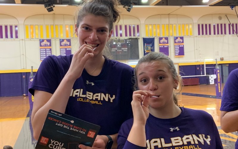 UAlbany volleyball players Danielle Tedesco (left) and Anna Chalupa taking the swab test in 2021.