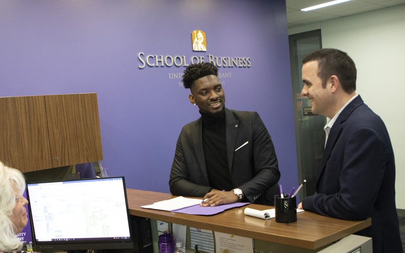 A student meets with an advisor at UAlbany's Massry School of Business main office.