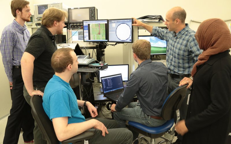 Professor and Associate Dean for Research Nathaniel Cady works with students in his lab on semiconductor research.