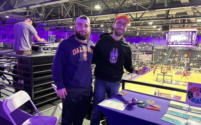 UAlbany Gift of Life Vice President Nick Tassielli and President Benjamin Marzouk stand next to a table with swab kits inside the Broadview Center.