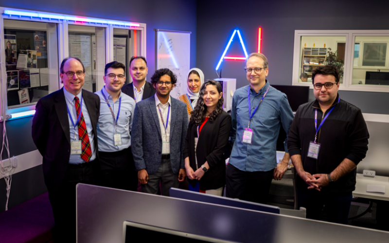 Information Science PhD Students with Keynote Speaker Jonathan Rochelle, Professor Abdullah Canbaz and Malcolm McPherson, member of the FIRST Board in the AI in Complex Systems Lab (Photo by Brian Busher)