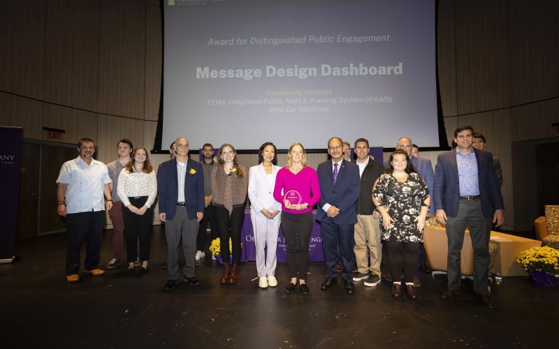 UAlbany researchers accept a campus award for Distinguished Public Engagement.
