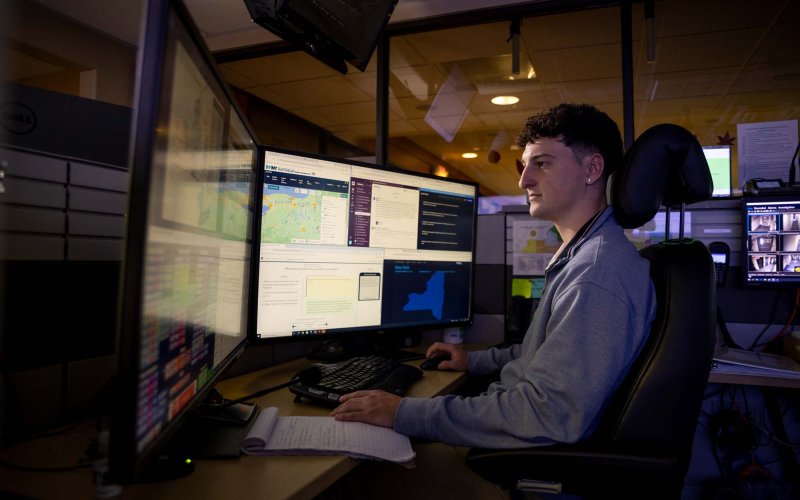 A student reviews multiple computer screens from the New York State Watch Center. 