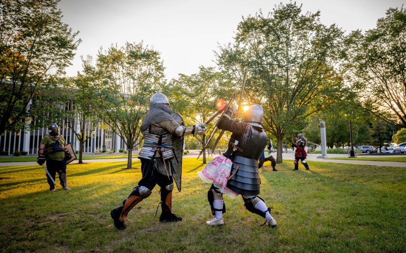 Living History Club members and off-campus advisor Avery Prokopowicz fight and practice combat techniques in leather and steel armor.