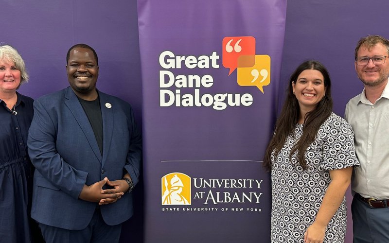 UAlbany community members stand by banner for the Great Dane Dialogue