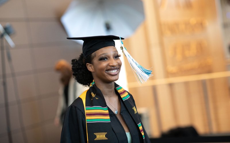 A student crosses the stage in the 2022 commencement at the UAlbany ETEC building