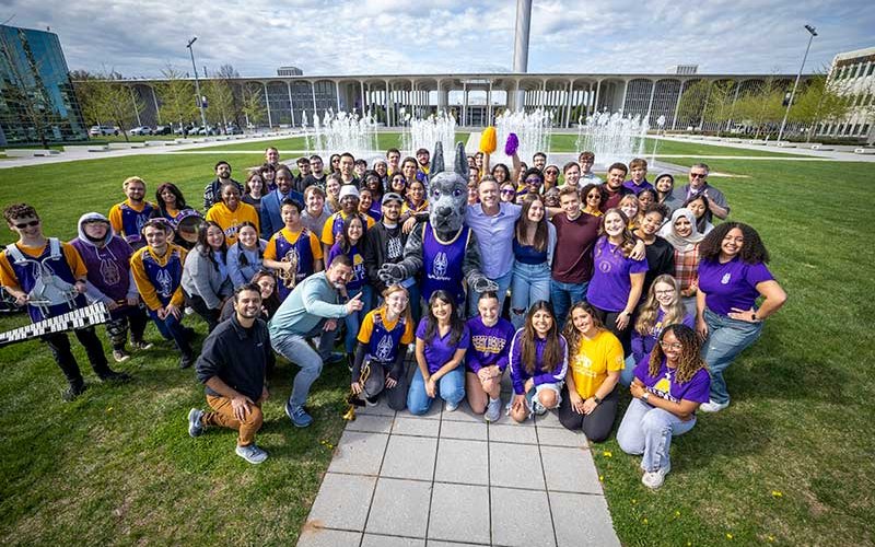 UAlbany students celebrate the filming of The College Tour with host Alex Boylan and UAlbany mascot Damien, the Great Dane