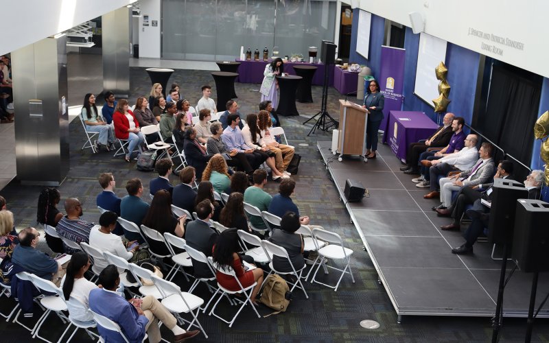 An audience of students, loved ones and professors listening to the dean speak at the awards ceremony. 