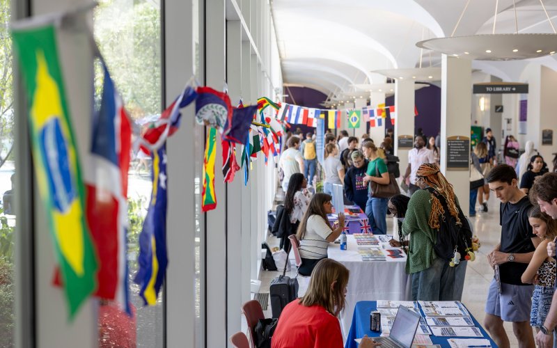 Students speak with staff members tabling an international education fair at UAlbany.