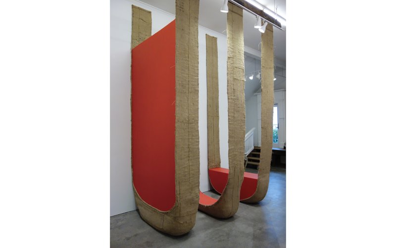 Large abstract sculptures reach up to the cieling of the exhibition space.