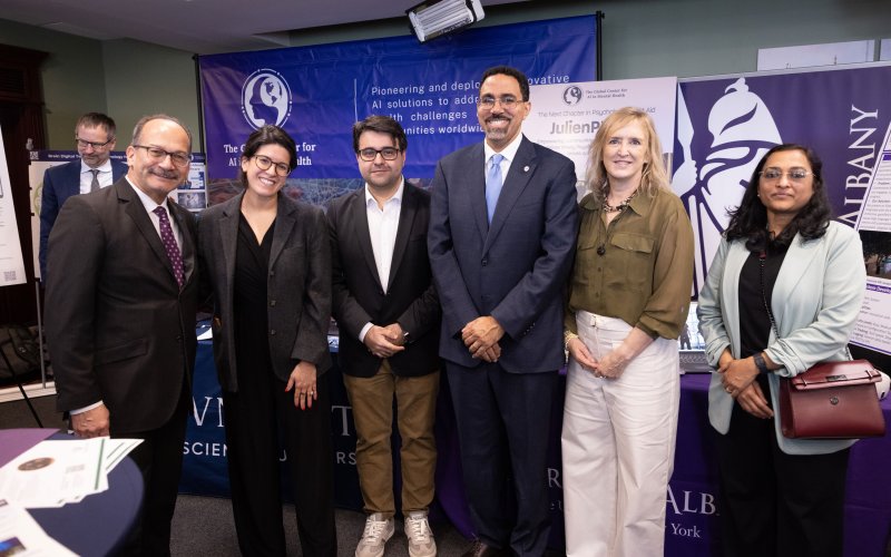 UAlbany President Havidán Rodríguez, SUNY Chancellor John B. King Jr., and four other individuals standing next to one another for a picture.
