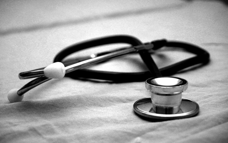 A stethoscope on top of a blanket.