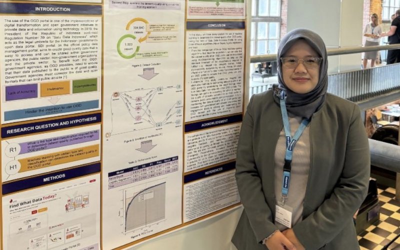 Student standing next to her presentation board