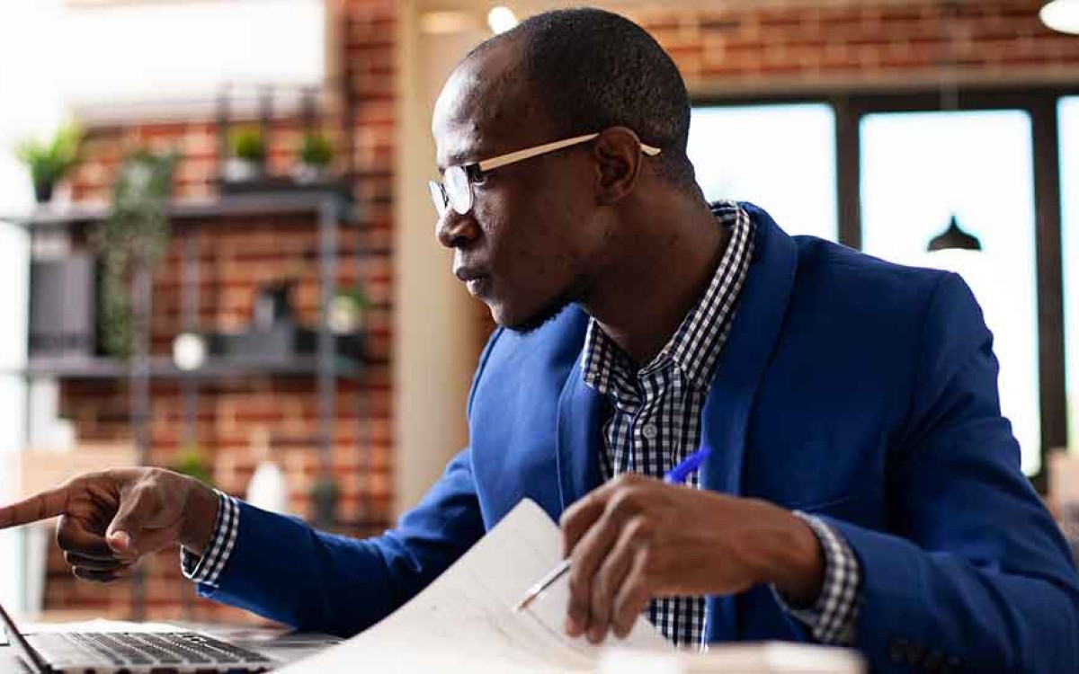A research associate at his desk reviews data from a psychological study.