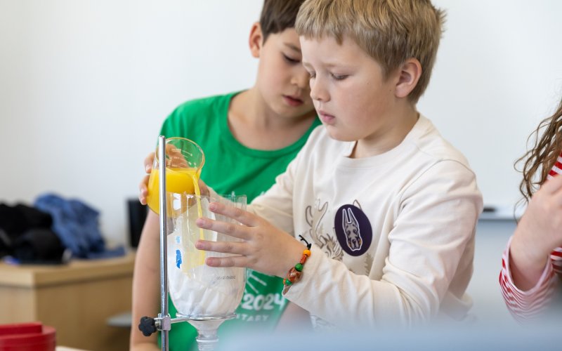 A child conducts a science experiment at ETEC during STEM and Earth Sciences Family Day.