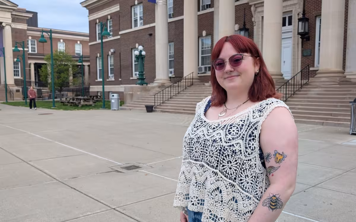 A portrait of Erin Forkin in front of the Downtown Campus.