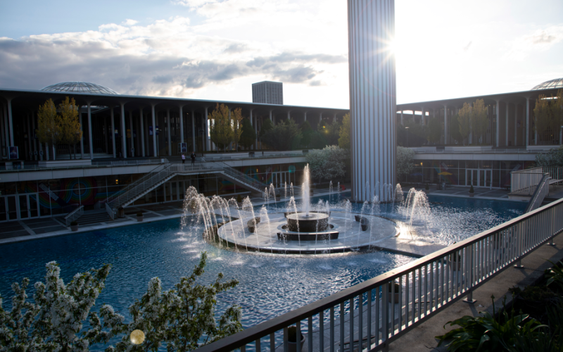 The Campus Center fountain running on a sunny day with the Carillon behind it.