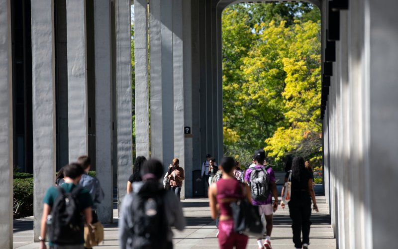 UAlbany Uptown campus with students walking ahead.