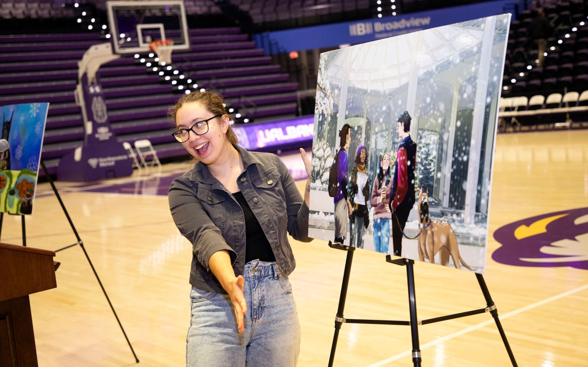 Student happily presents winning artwork for winter greeting card 