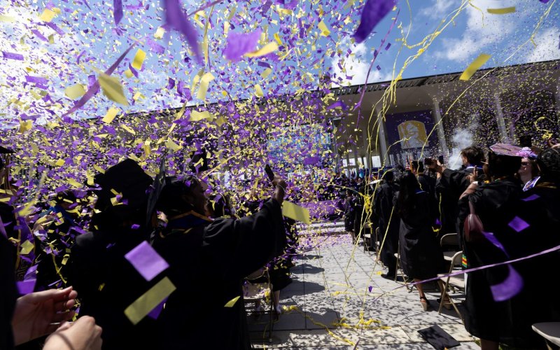 students surrounded by confetti at UAlbany's 2025 Commencement ceremonies
