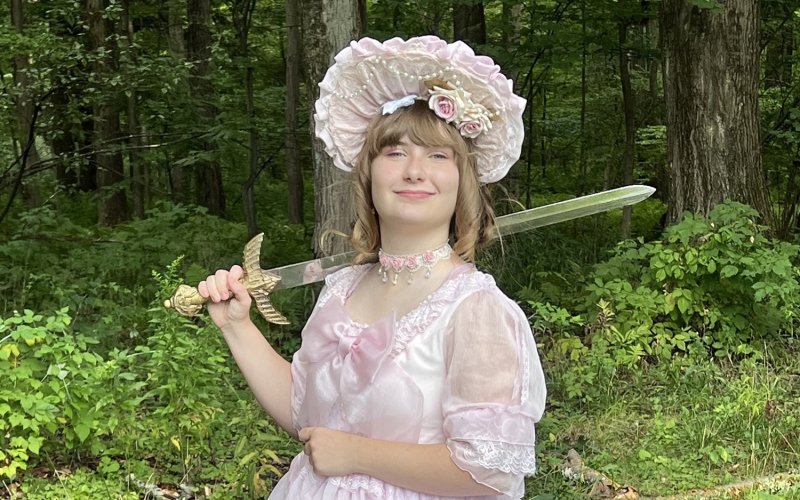 Sophie Breunig holds up a sword used as part of the UAlbany Living History Club.