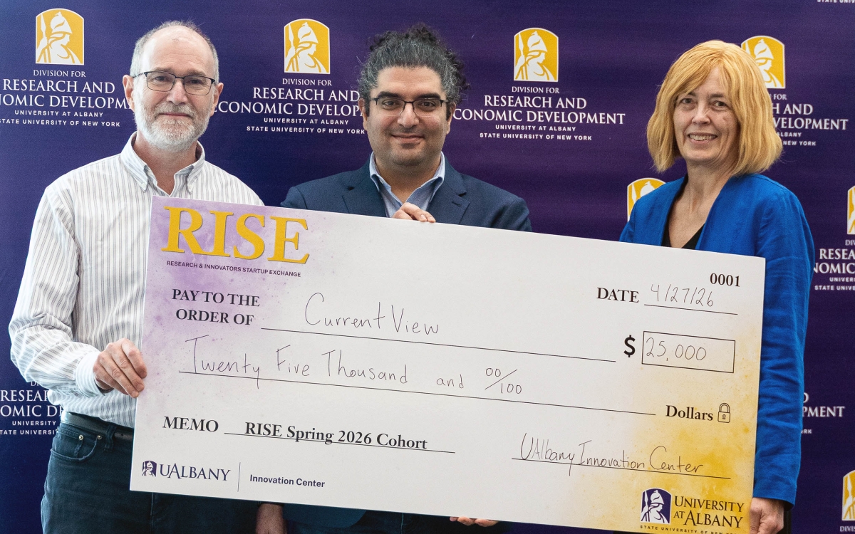 Members of the "current view" team hold a check for 25,000 after winning the annual RISE Demo Day competition at UAlbany.