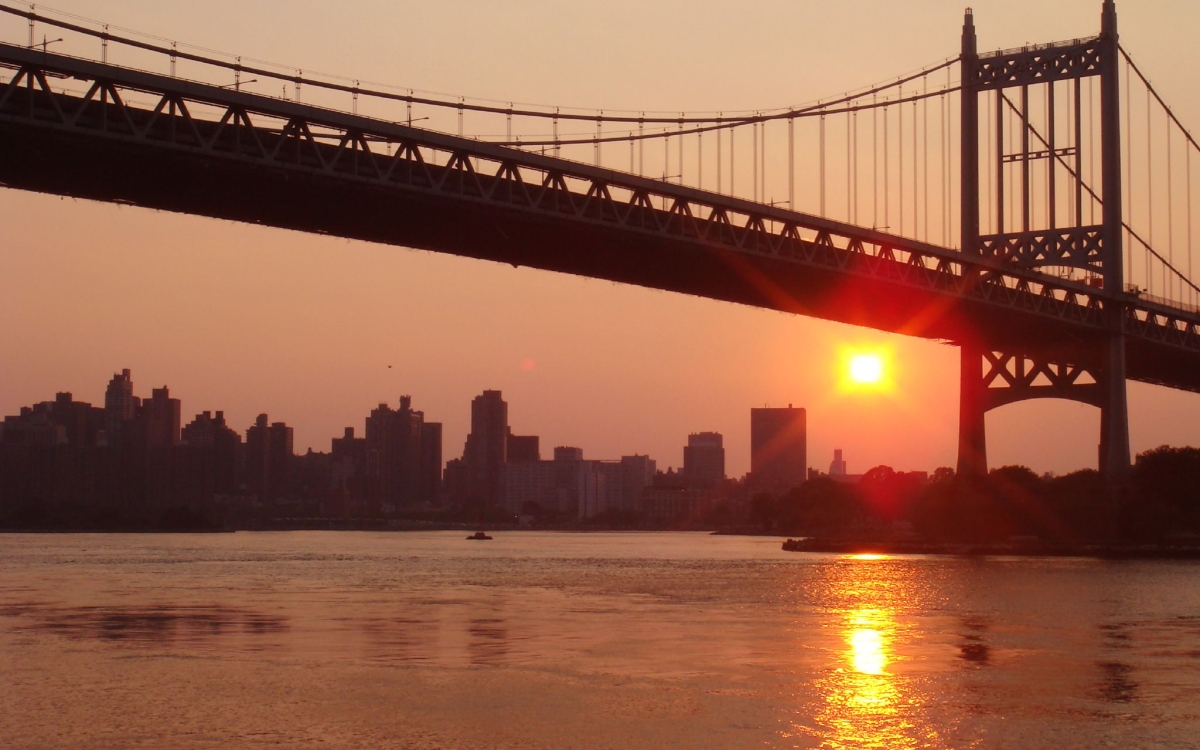 A heatwave sunset under a bridge in Astoria Park.