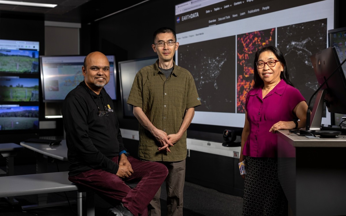 UAlbany researchers stand in front of screens inside the xCITE Laboratory at ETEC.