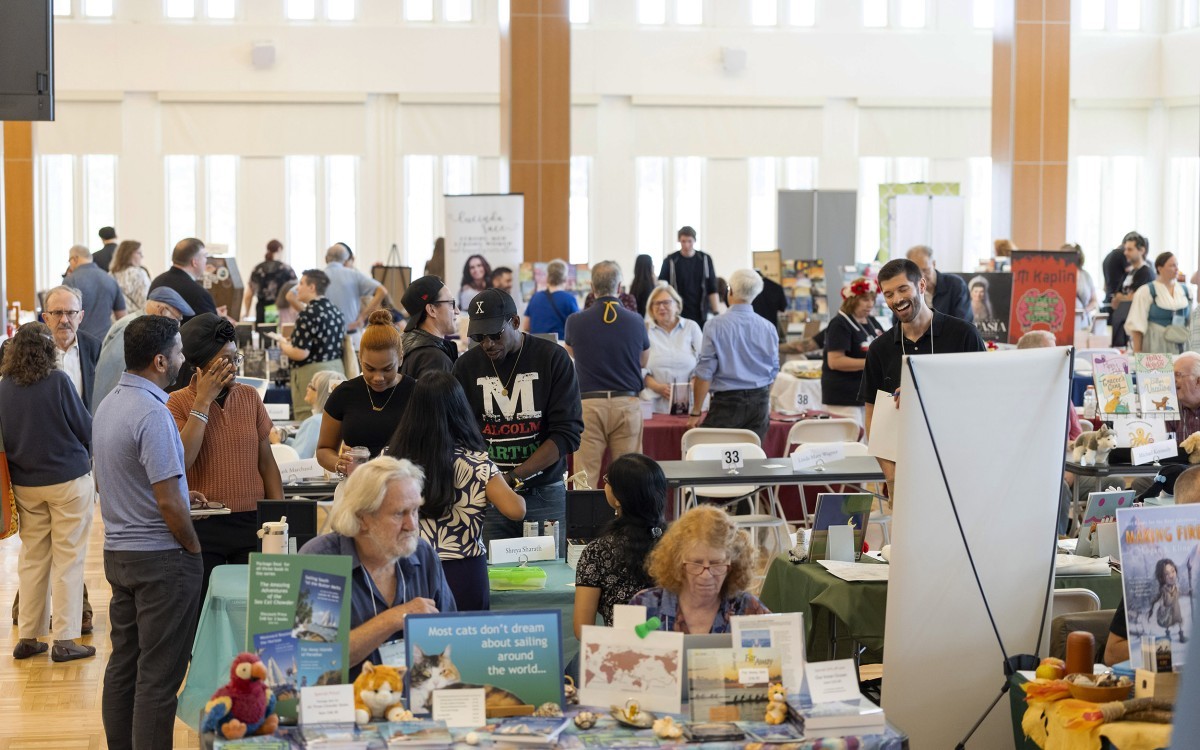 Patrons mull about the Campus Center ballroom at UAlbany moving through rows of books on display during the Albany Book Festival.