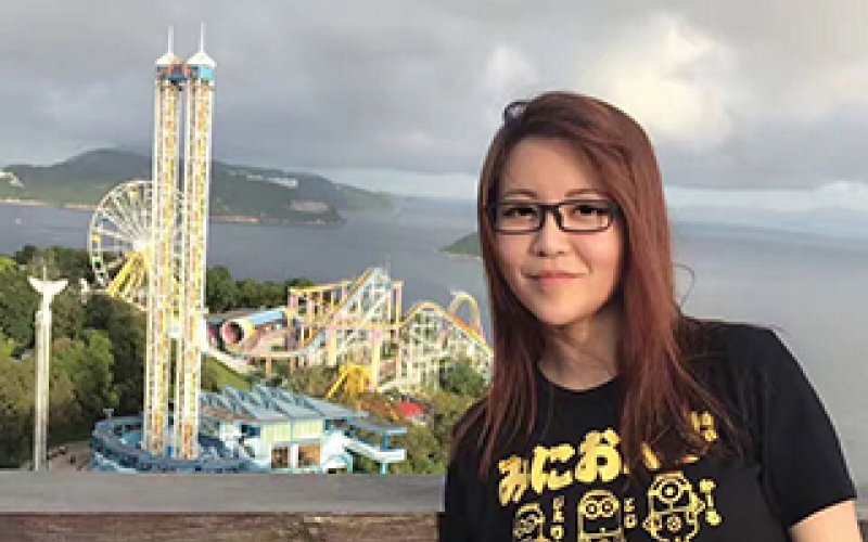 Lin Zho pauses on a hilltop overlooking Ocean Park in Hong Kong in the summer of 2017.
