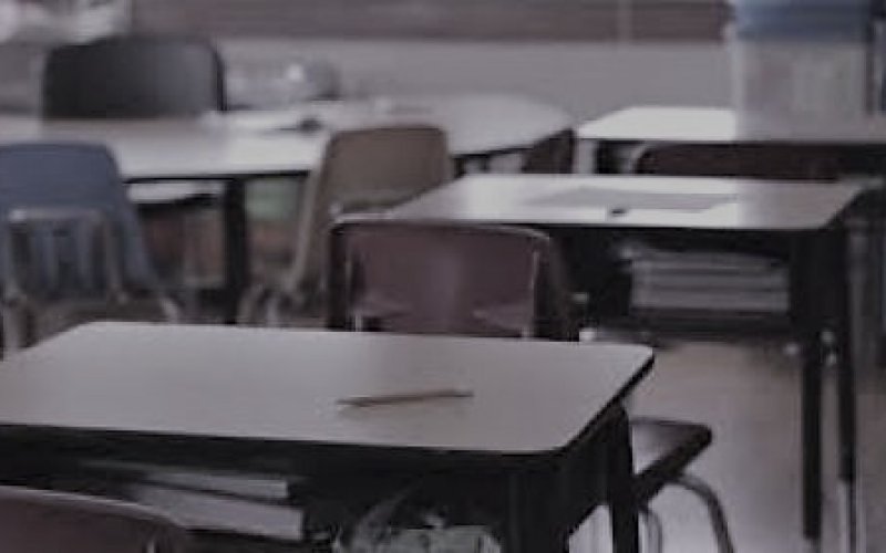 empty school desk with pencil on it