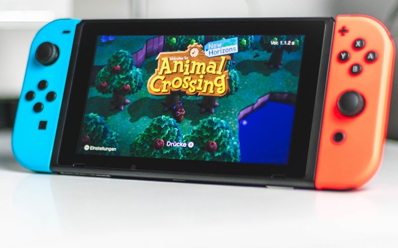 The video game “Animal Crossings: New Horizons," is shown on a colorful widescreen iPhone