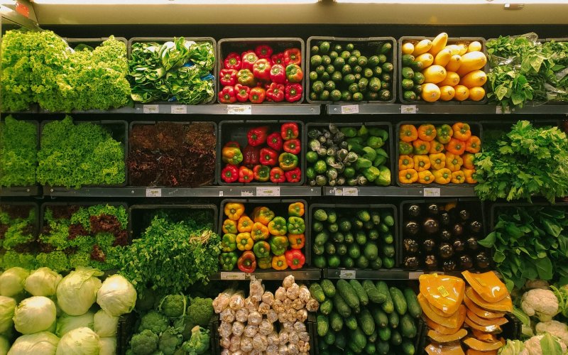 Vegetables along the wall of a grocery store.