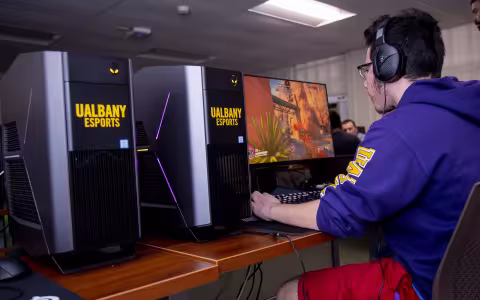 Photo of a UAlbany eSports student in the competitive gaming arena at Draper Hall.