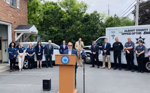 Carmen Morano, Associate Dean for Research in the School of Social Welfare, speaking at the podium during the press conference announcing the program.