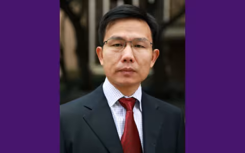 Kai Zhang smiles at the camera.